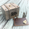 Miniature treasure chest with wood Ouija board and planchette inside mirror